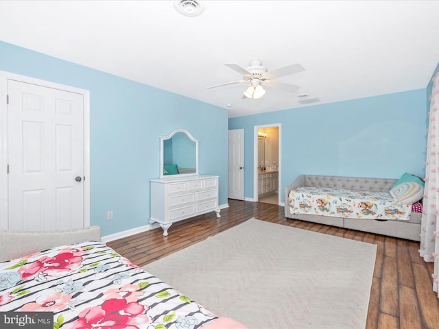 bedroom featuring baseboards, ensuite bathroom, wood-type flooring, and a ceiling fan