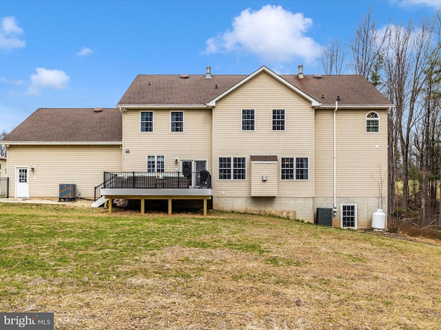 rear view of house featuring a lawn, a shingled roof, central AC, and a wooden deck