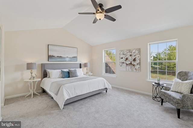 carpeted bedroom with baseboards, multiple windows, a ceiling fan, and vaulted ceiling