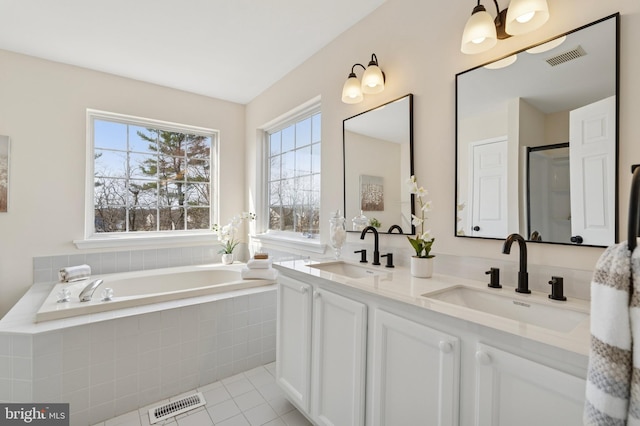 bathroom with a sink, visible vents, and a bath