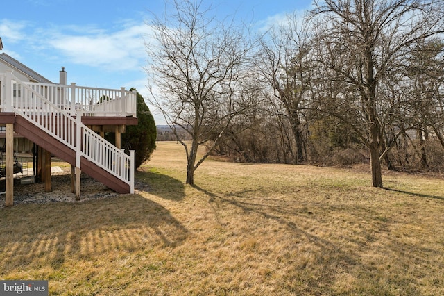 view of yard with stairway and a wooden deck