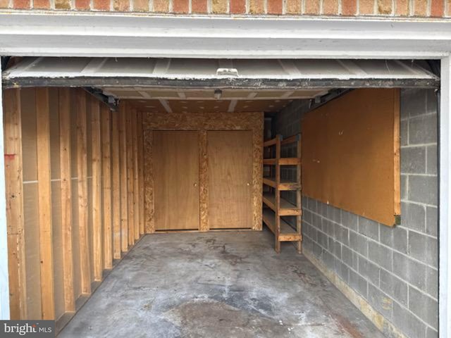 garage with concrete block wall