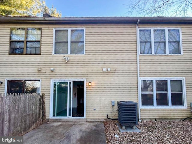 back of house with cooling unit, a patio, and fence