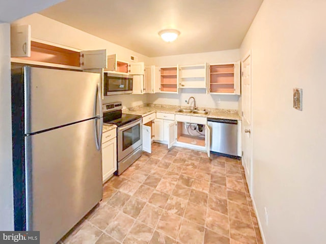 kitchen featuring baseboards, open shelves, a sink, stainless steel appliances, and white cabinets