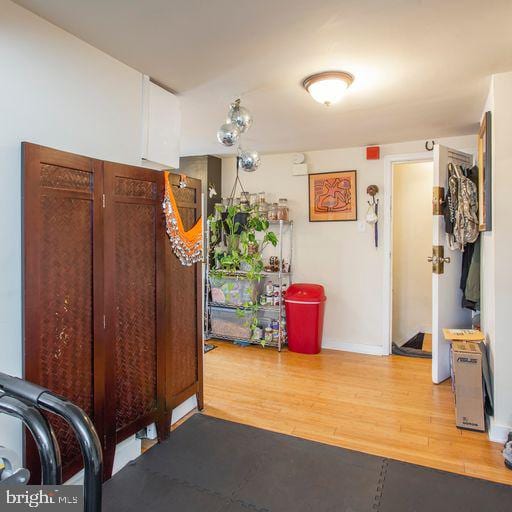 interior space featuring light wood-type flooring and baseboards