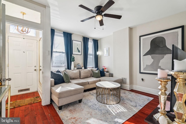 living room with visible vents, ceiling fan, baseboards, and wood finished floors