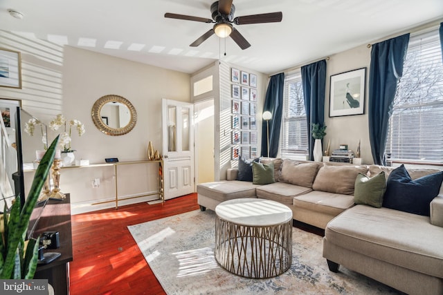 living area with ceiling fan and wood finished floors