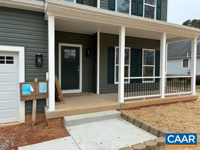 entrance to property with a garage and covered porch