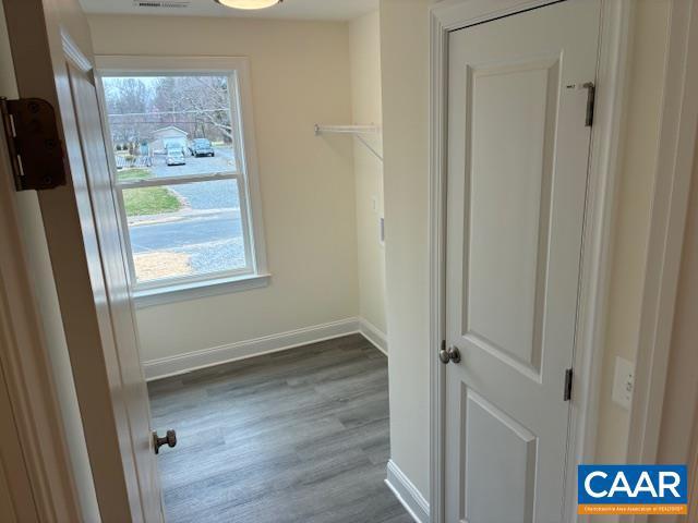 walk in closet featuring visible vents and wood finished floors