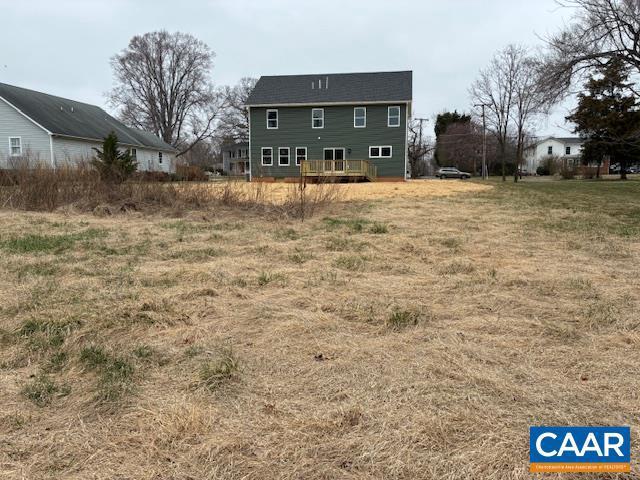 back of house featuring a wooden deck