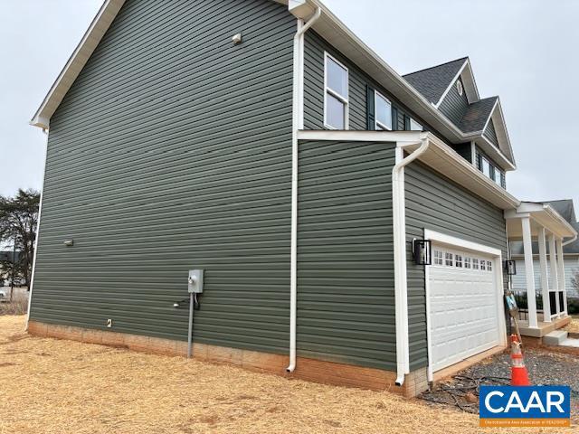 view of side of home featuring an attached garage