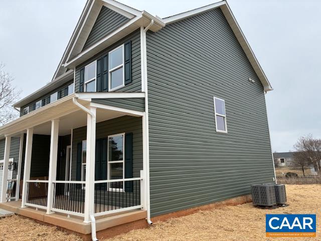 view of side of property featuring central AC