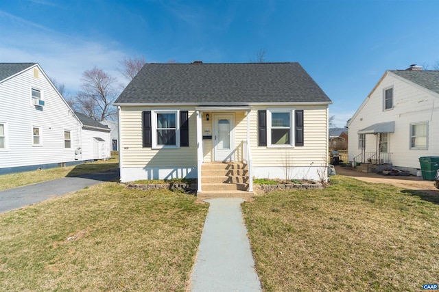 bungalow with a front lawn and a shingled roof