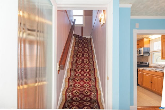 stairway featuring crown molding