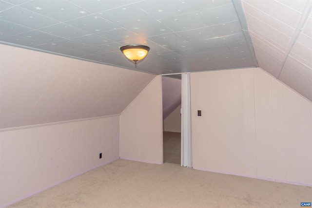 bonus room with lofted ceiling and carpet