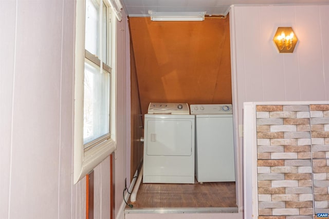 clothes washing area with washer and clothes dryer and laundry area