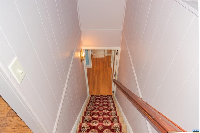 stairs featuring wooden walls