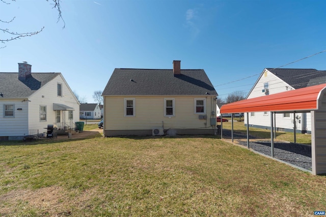 back of house with a carport, a lawn, roof with shingles, and a chimney