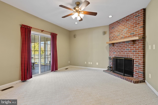 unfurnished living room with visible vents, a ceiling fan, carpet, baseboards, and a brick fireplace