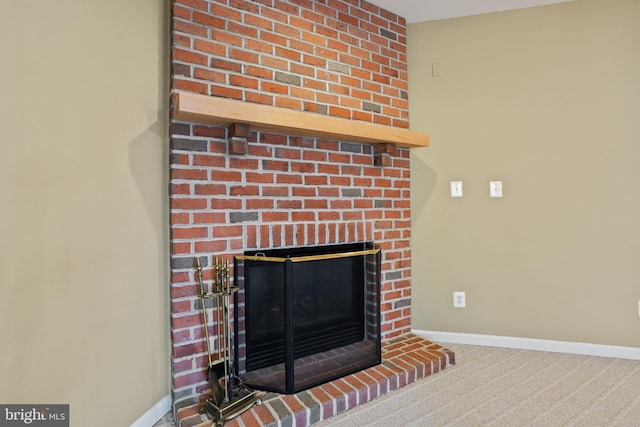 interior details featuring baseboards, a brick fireplace, and carpet flooring