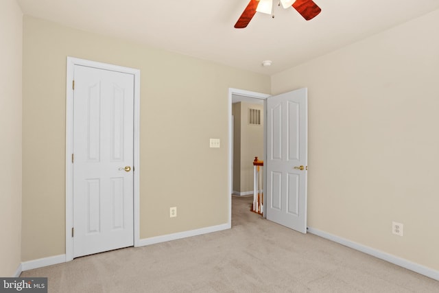 unfurnished bedroom featuring baseboards, carpet, and ceiling fan