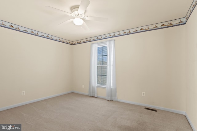 empty room featuring visible vents, baseboards, carpet, and a ceiling fan