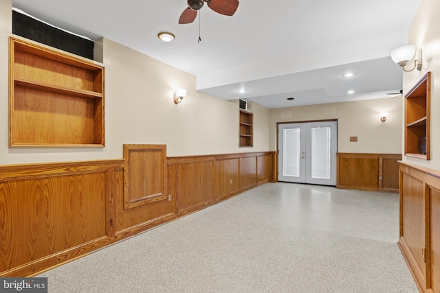 interior space featuring recessed lighting, french doors, wooden walls, wainscoting, and ceiling fan