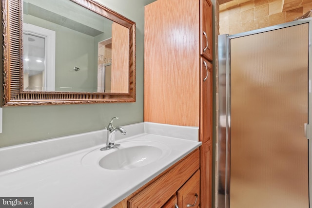 bathroom with a stall shower and vanity