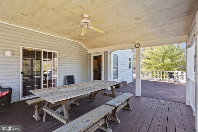 wooden deck featuring outdoor dining space and a ceiling fan