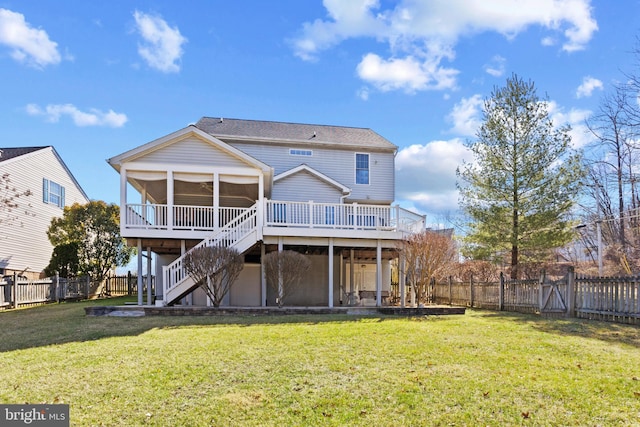 back of house featuring a wooden deck, a lawn, a fenced backyard, and stairs