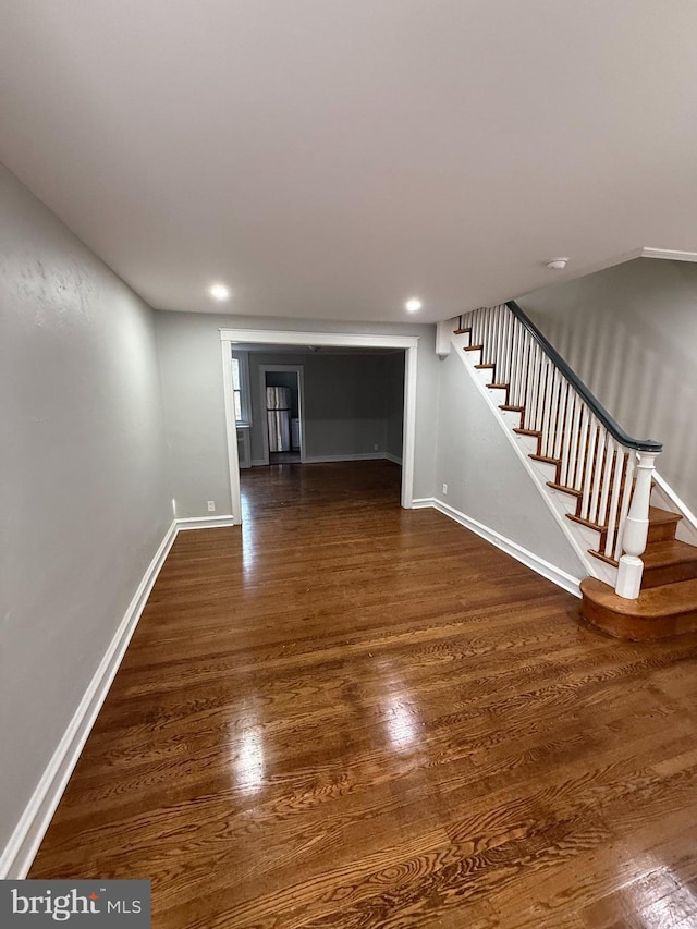 interior space featuring stairs, recessed lighting, wood finished floors, and baseboards