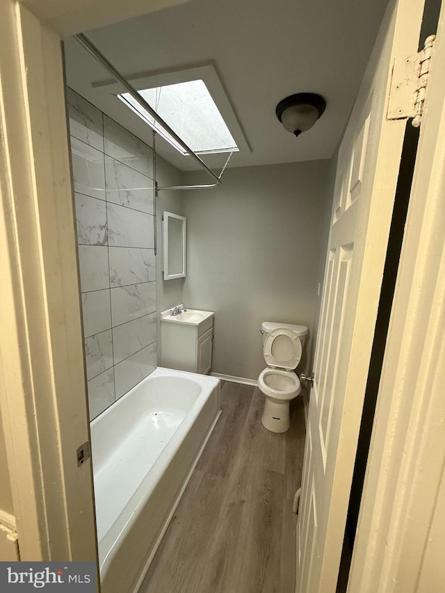 full bathroom featuring toilet, vanity, and wood finished floors