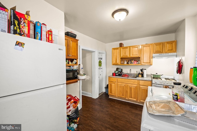 kitchen featuring white appliances, open shelves, a sink, dark wood-type flooring, and under cabinet range hood