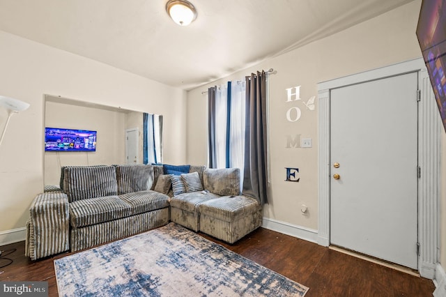 living area featuring baseboards and wood finished floors