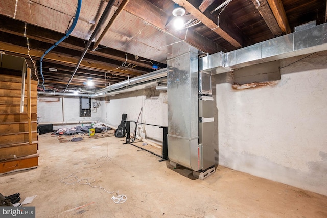 unfinished basement featuring heating unit