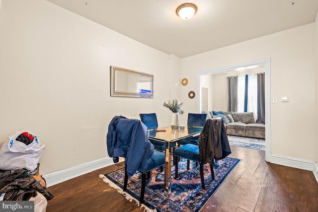 dining area with baseboards and wood-type flooring