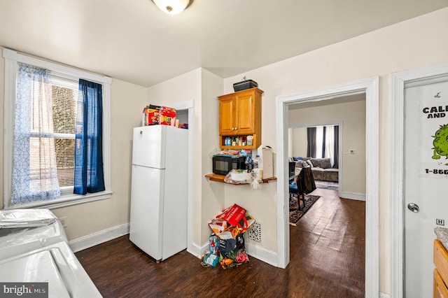 kitchen with dark wood finished floors, baseboards, freestanding refrigerator, and black microwave