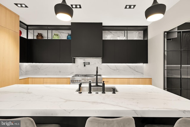 kitchen with light stone countertops, modern cabinets, and dark cabinets