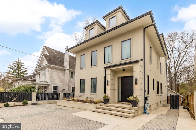 view of front of property featuring fence and stucco siding