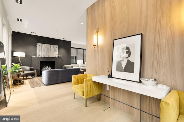 living room with a fireplace and wood finished floors