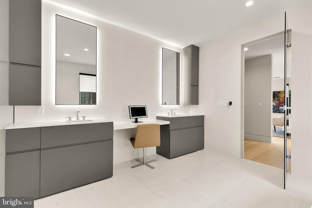 full bath featuring a sink and two vanities