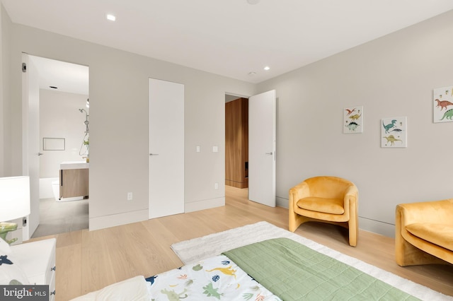 bedroom with recessed lighting and light wood-style flooring