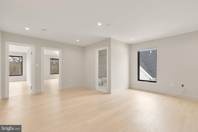 empty room with recessed lighting, baseboards, and light wood-style flooring