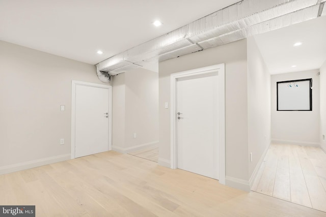 interior space featuring recessed lighting, baseboards, and light wood-type flooring