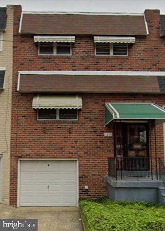 view of front of house featuring brick siding, concrete driveway, and a garage