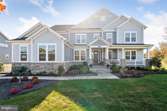 26535 Henry Hill Dr, Centreville, VA 20120 - craftsman-style house with stone siding, a front lawn, and covered porch