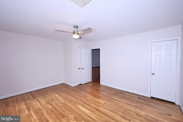 spare room featuring visible vents, baseboards, light wood-style floors, and a ceiling fan