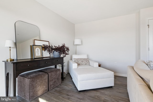 living area with baseboards and wood finished floors