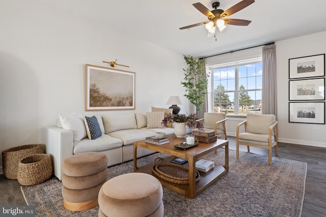 living area featuring baseboards, wood finished floors, and a ceiling fan