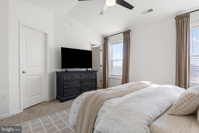 bedroom with a ceiling fan, carpet, visible vents, baseboards, and vaulted ceiling